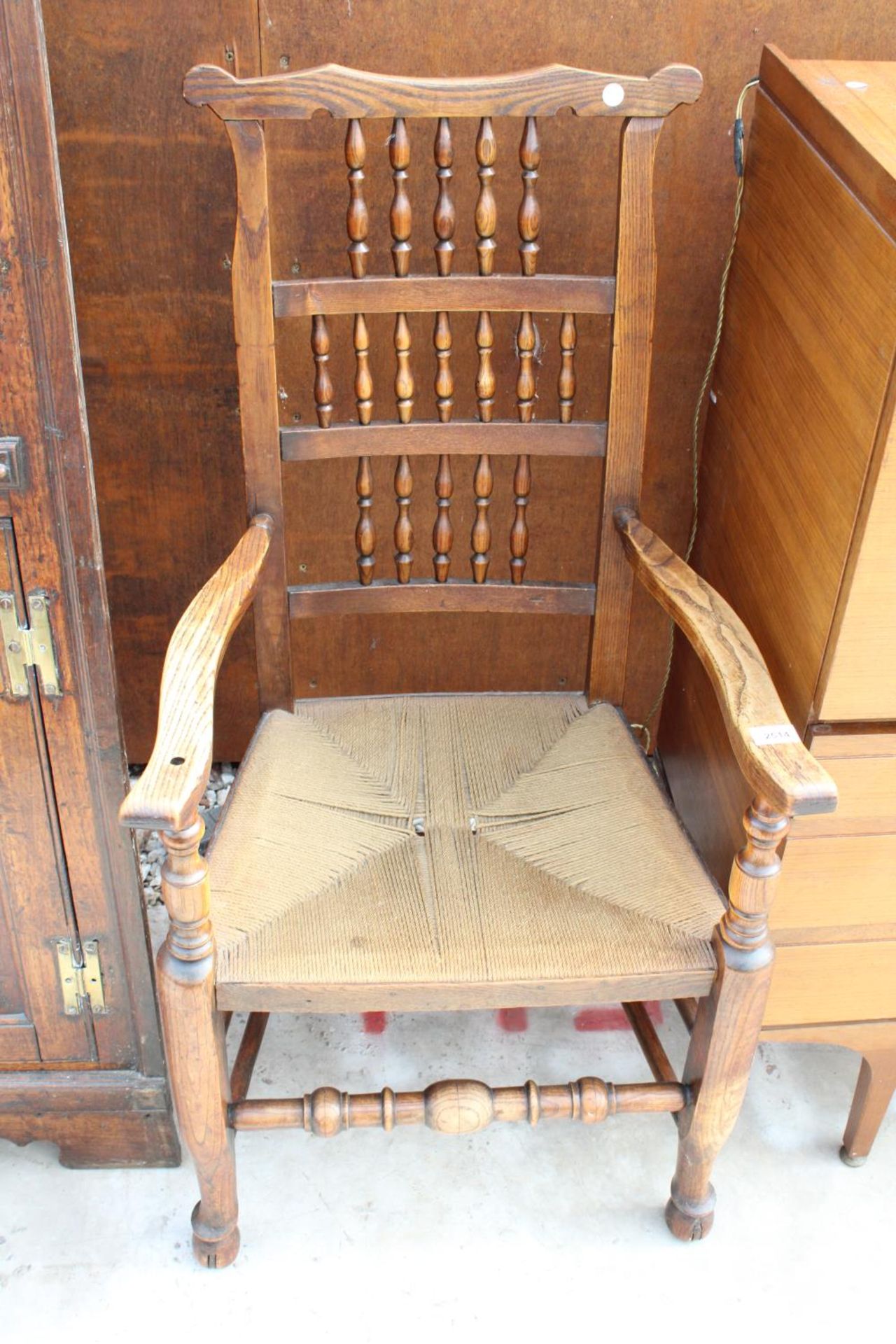 AN 18TH CENTURY STYLE ELM SPINDLE-BACK CARVER CHAIR WITH RUSH SEAT