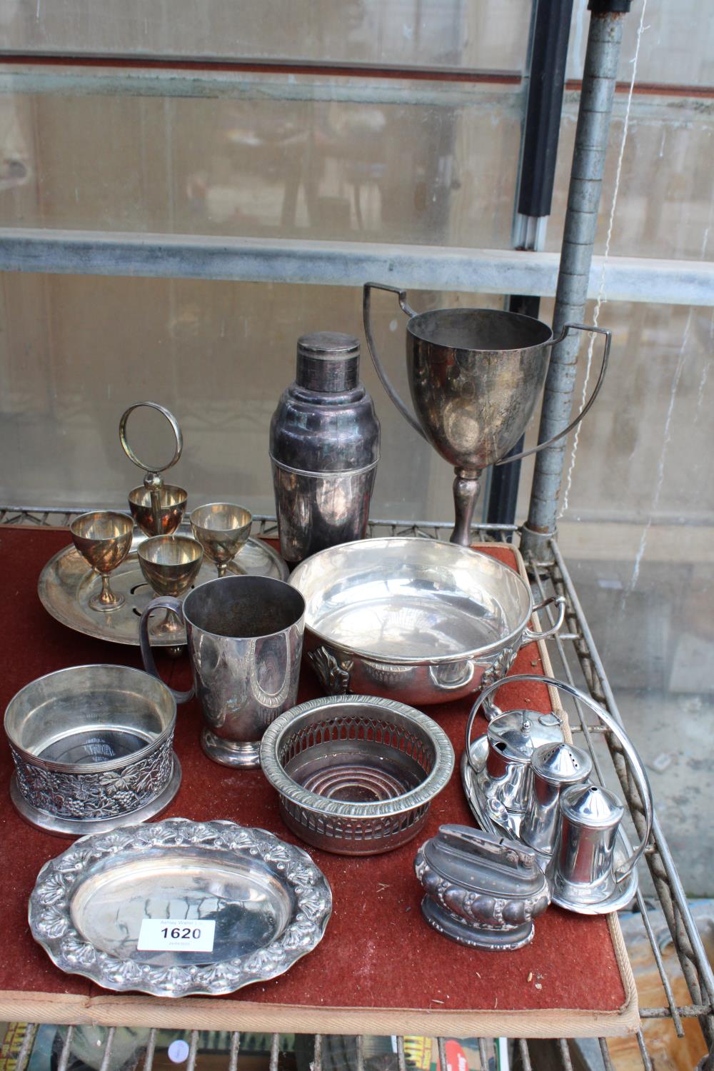 AN ASSORTMENT OF SILVER PLATED ITEMS TO INCLUDE A TROPHY, A COCKTAIL SHAKER AND WINE BOTTLE COASTERS