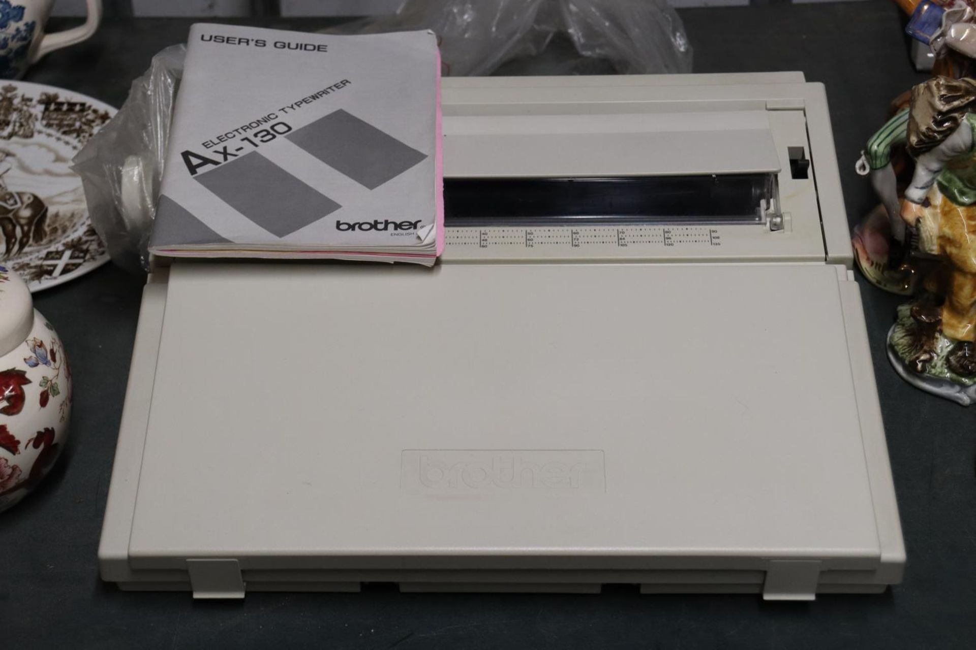 A BROTHER AX-130 ELECTRIC TYPEWRITER AND USER'S GUIDE