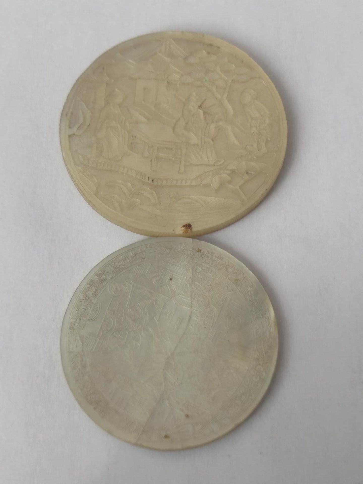 TWO VINTAGE HAND CARVED, MOTHER OF PEARL GAMING TOKENS (ONE A/F)