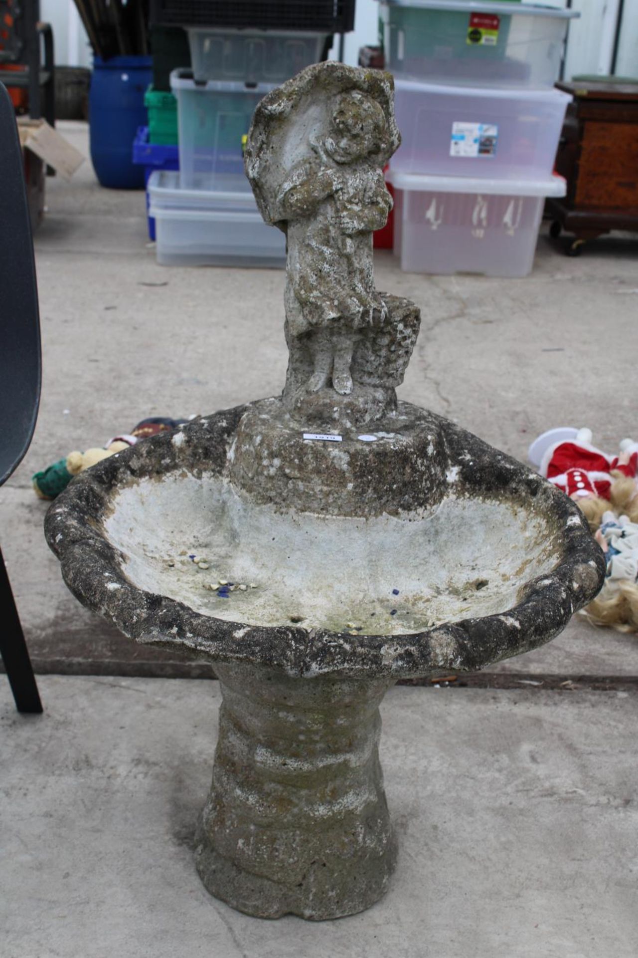 A DECORATIVE RECONSTITUTED STONE BIRD BATH