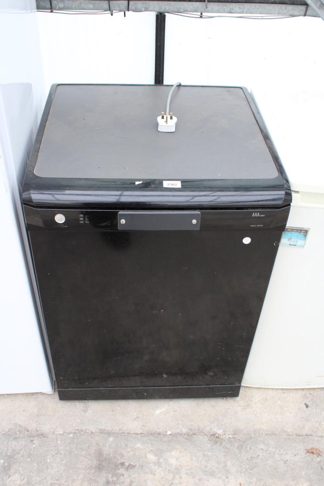 A BLACK UNDERCOUNTER DISH WASHER