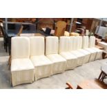 A SET OF EIGHT MODERN UPHOSTERED AND SKIRTED DINING CHAIRS