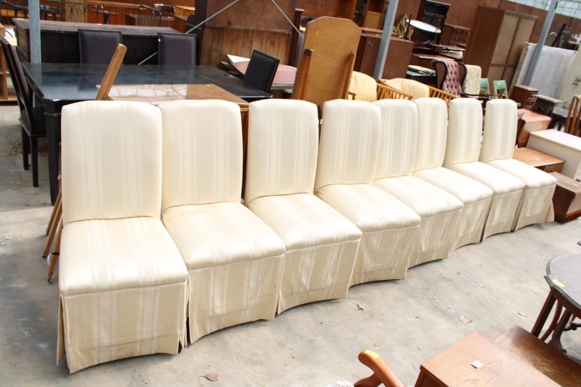 A SET OF EIGHT MODERN UPHOSTERED AND SKIRTED DINING CHAIRS