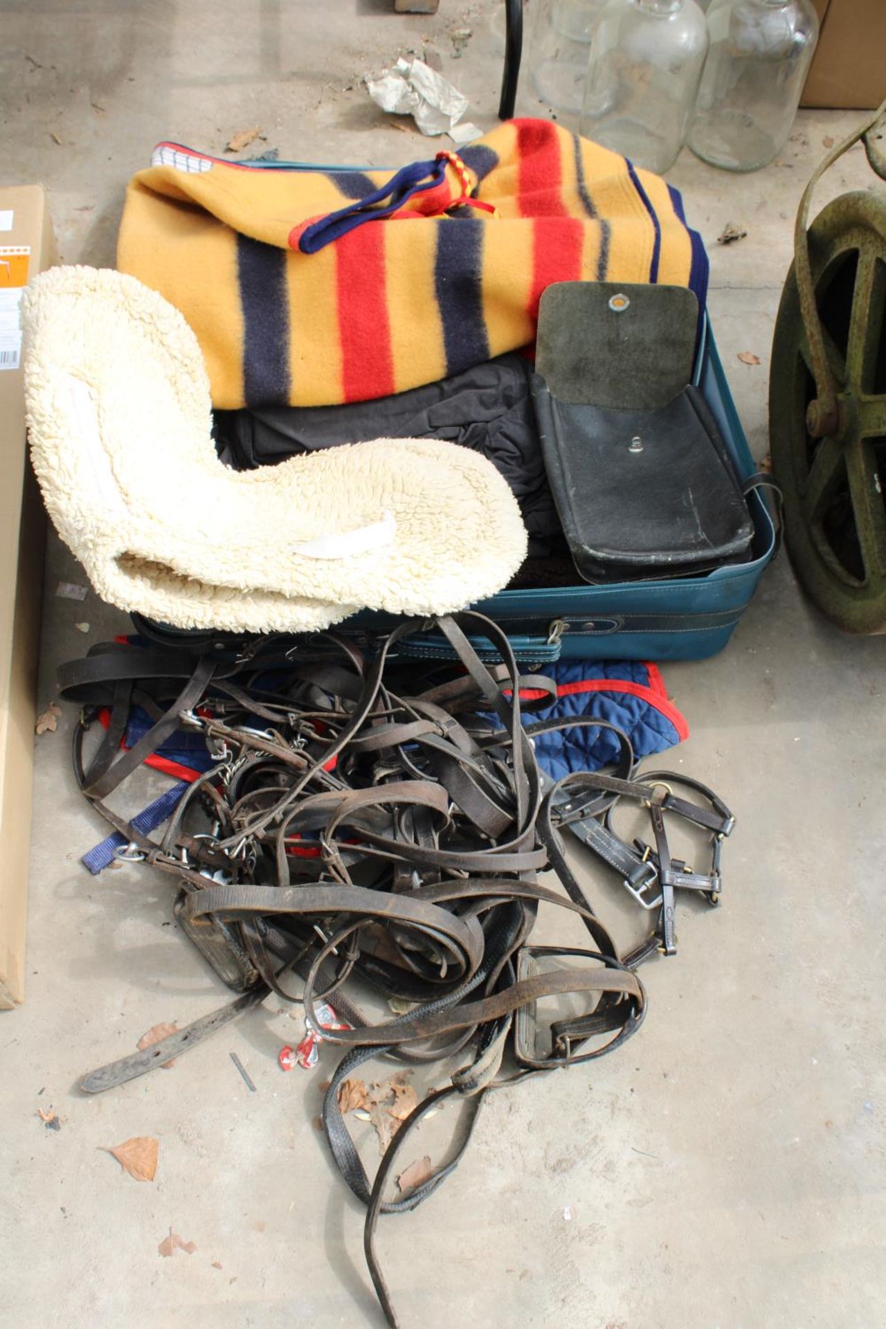 AN ASSORTMENT OF HORSE TACK TO INCLUDE HEAD COLLARS AND NUMBNERS ETC