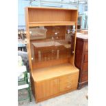 A RETRO TEAK UNIT WITH SMOKED GLASS DOORS, CUPBOARD AND DRAWERS TO BASE. 39.5" WIDE