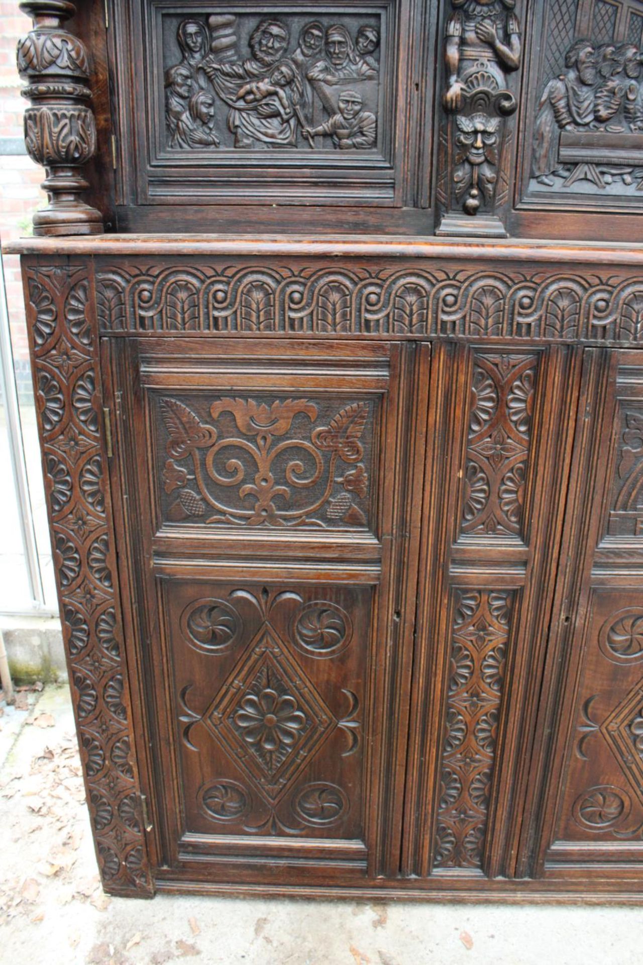 AN OAK GEORGE III STYLE COURT CUPBOARD WITH CARVED PANELS, THREE DEPICTING THE BIRTH AND - Image 9 of 13