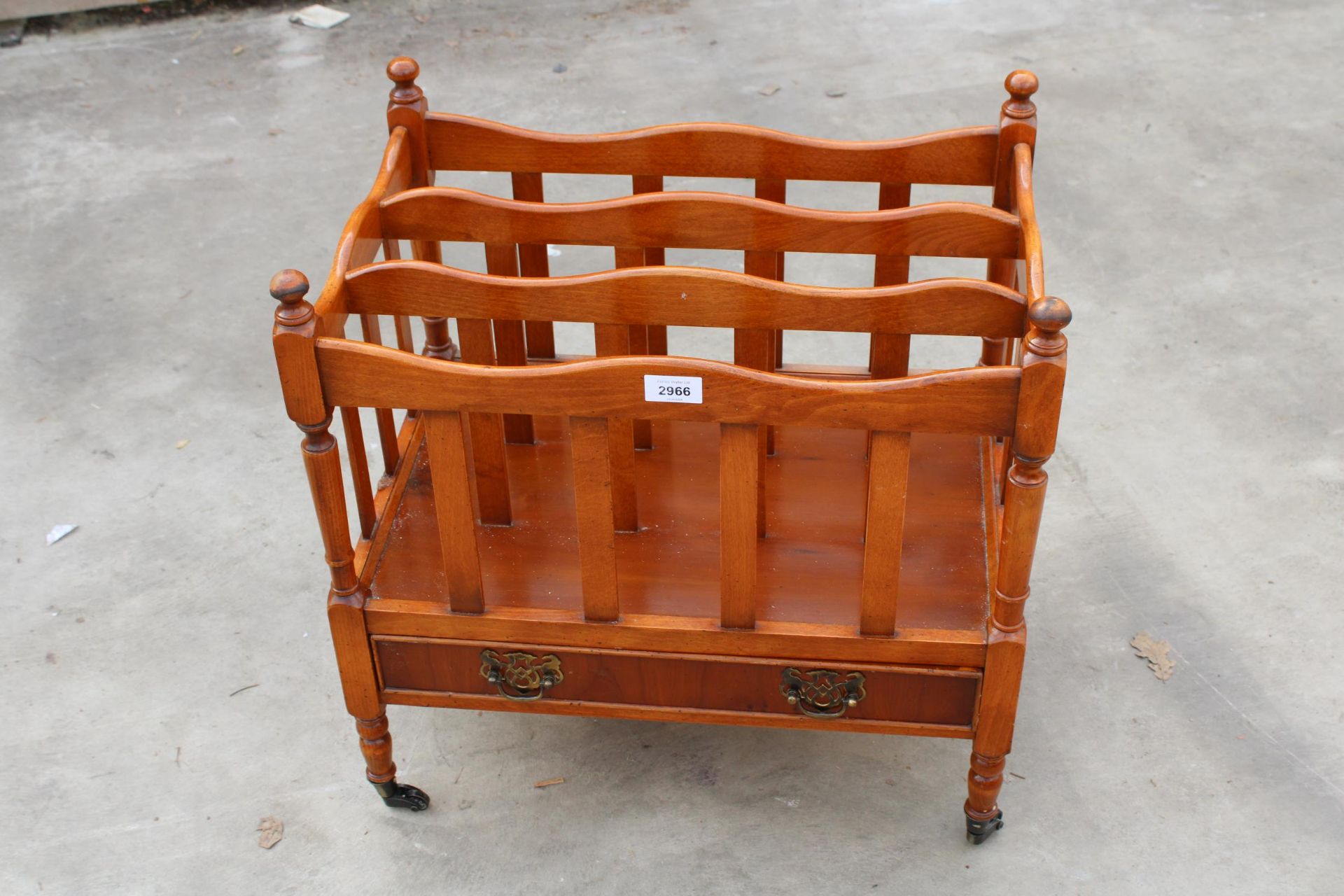 A REGENCY STYLE YEW WOOD THREE DIVISION CANTERBURY MAGAZINE RACK WITH LOWER DRAWER