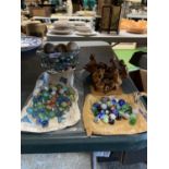A QUANTITY OF MARBLES TO INCLUDE A GLASS JELLY MOULD, THREE VINTAGE BALLS PLUS TWO WOODEN FIGURE