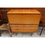 A RETRO TEAK BUREAU WITH DROP-DOWN FLAP, 2 SHORT AND 2 LONG DRAWERS TO BASE