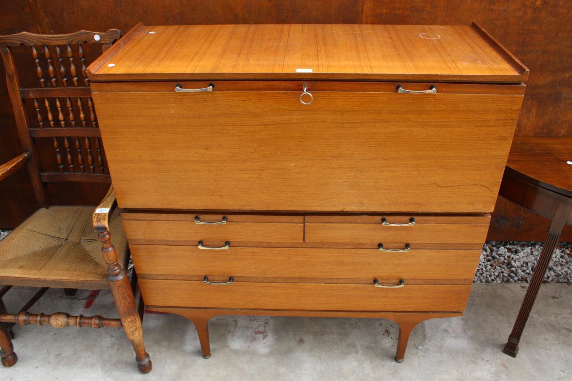 A RETRO TEAK BUREAU WITH DROP-DOWN FLAP, 2 SHORT AND 2 LONG DRAWERS TO BASE