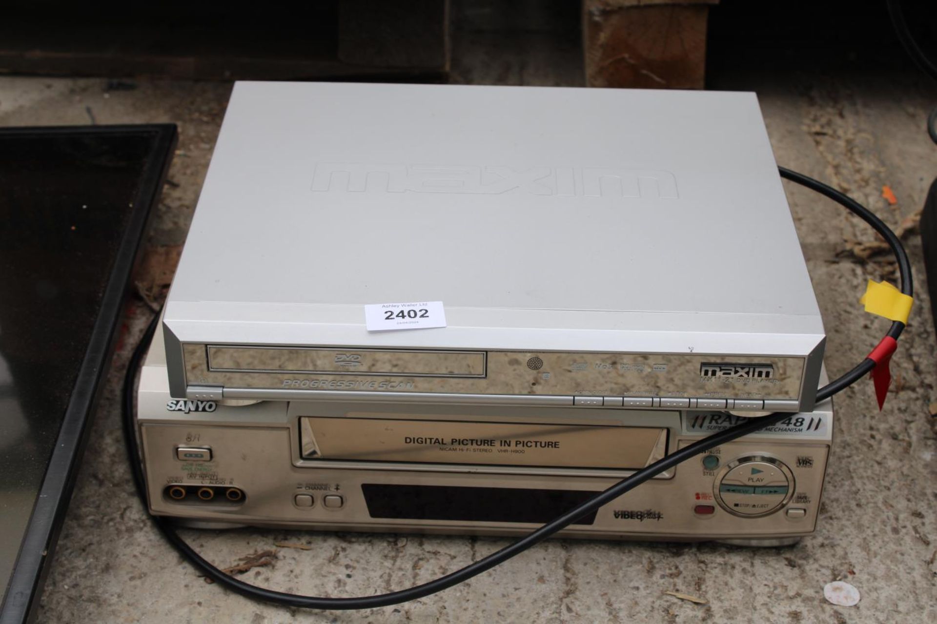 A MAXIM DVD PLAYER AND A SANYO VHS PLAYER