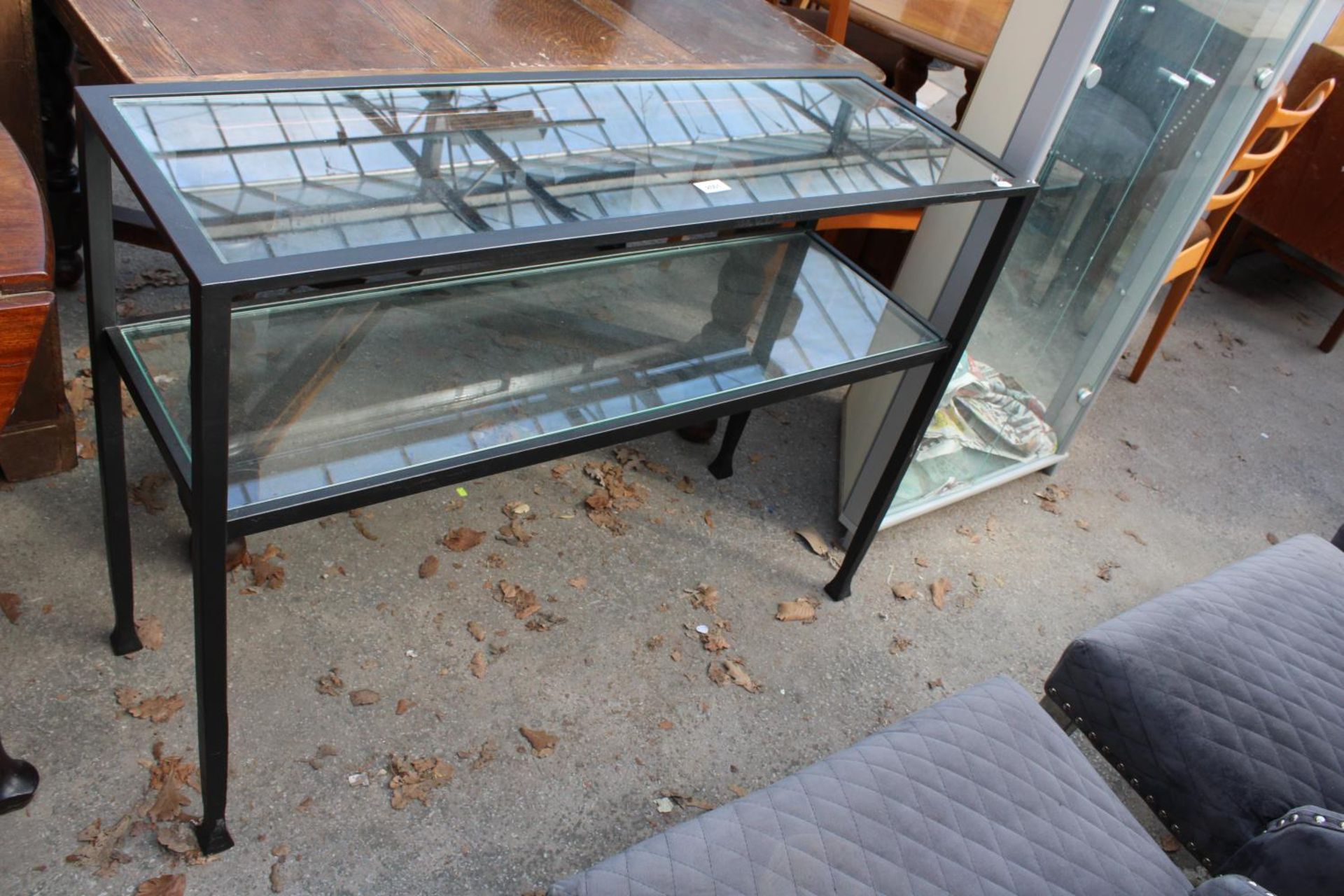 A MODERN BLACK METAL FRAME 2 TIER SIDE-TABLE WITH INSET GLASS TOP AND SHELF, 42" WIDE