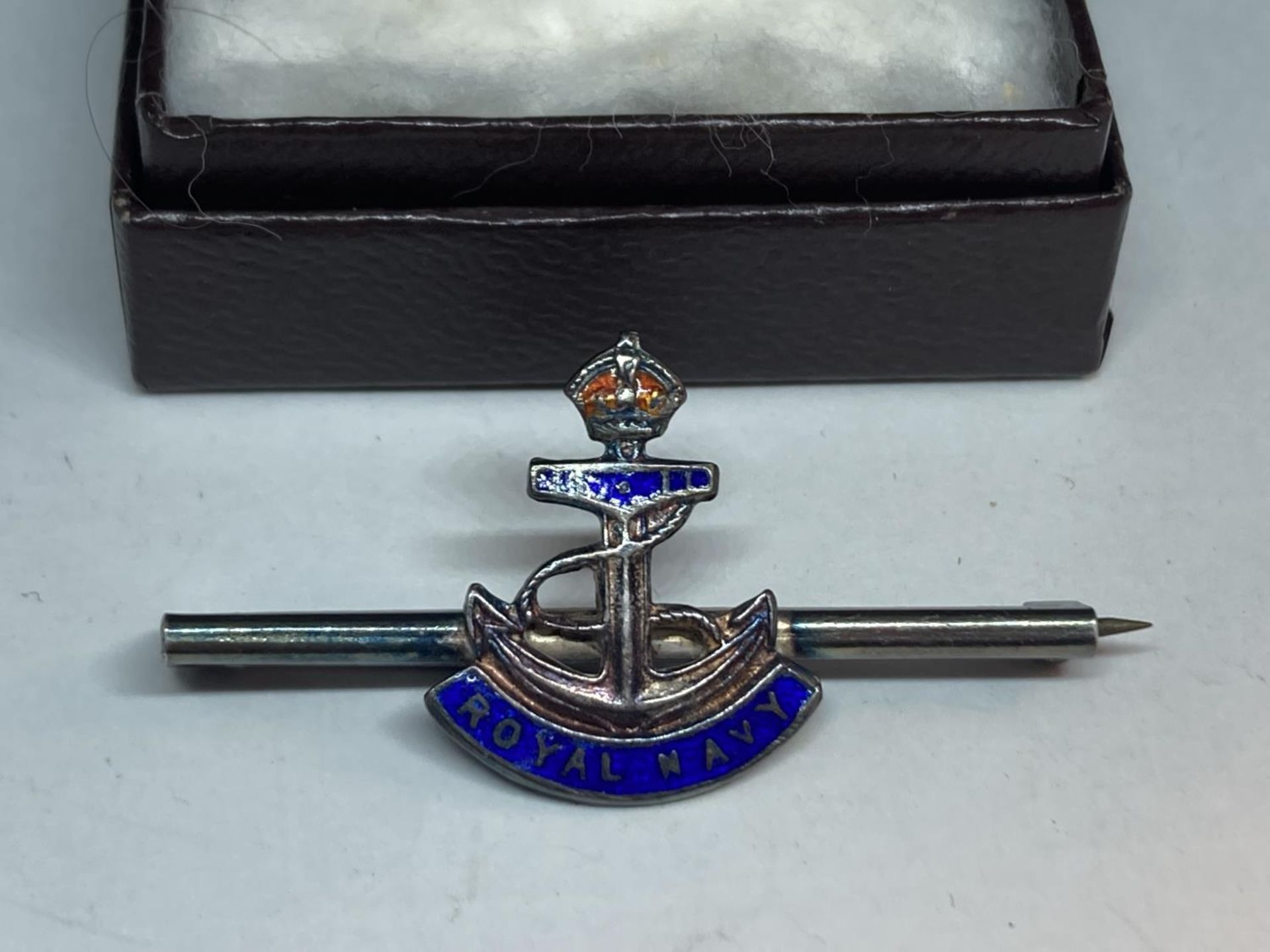 A SILVER AND ENAMEL ROYAL NAVY BADGE