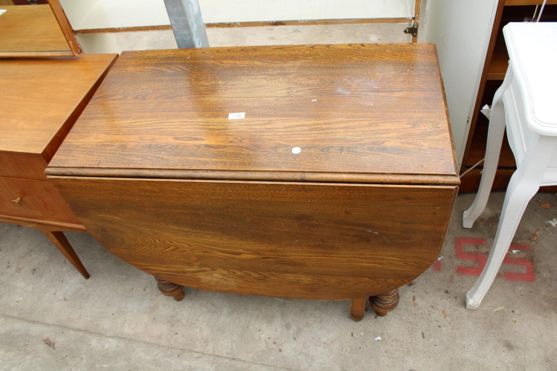 AN EARLY 20TH CENTURY OAK DROP-LEAF DINING TABLE ON TURNED AND FLUTED LEGS, 60" X 36" OPENED