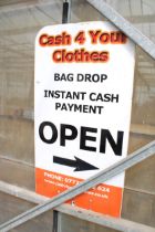 A METAL 'CASH 4 YOUR CLOTHES' SIGN