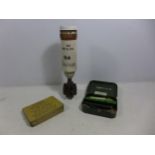 A 20TH CENTURY INERT MORTAR SHELL, A GUN CLEANING KIT AND AN ANTI GAS TIN