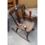 A VICTORIAN STYLE BEECH CHILDS ROCKING CHAIR WITH BULLSEYE BACK