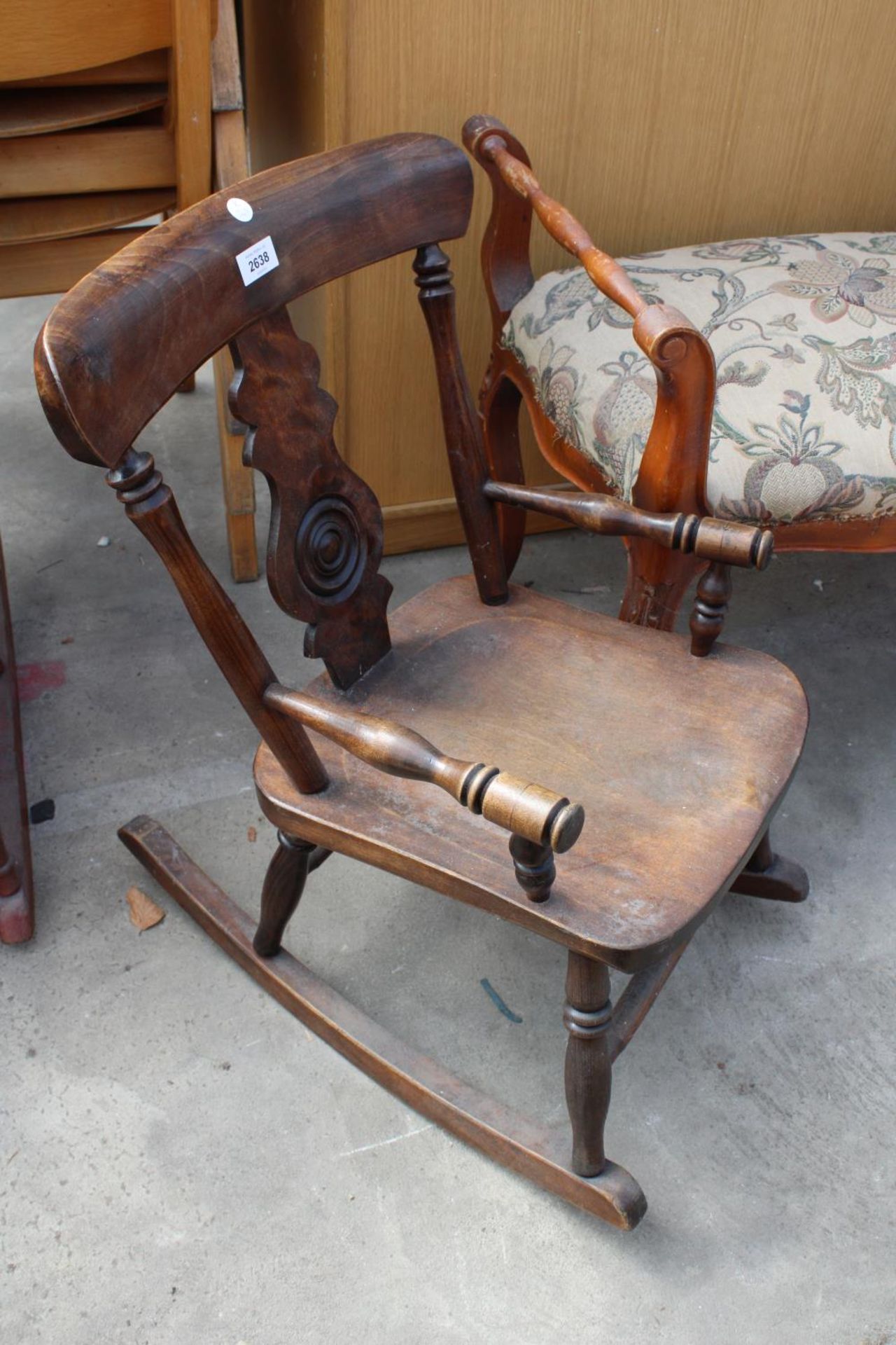 A VICTORIAN STYLE BEECH CHILDS ROCKING CHAIR WITH BULLSEYE BACK
