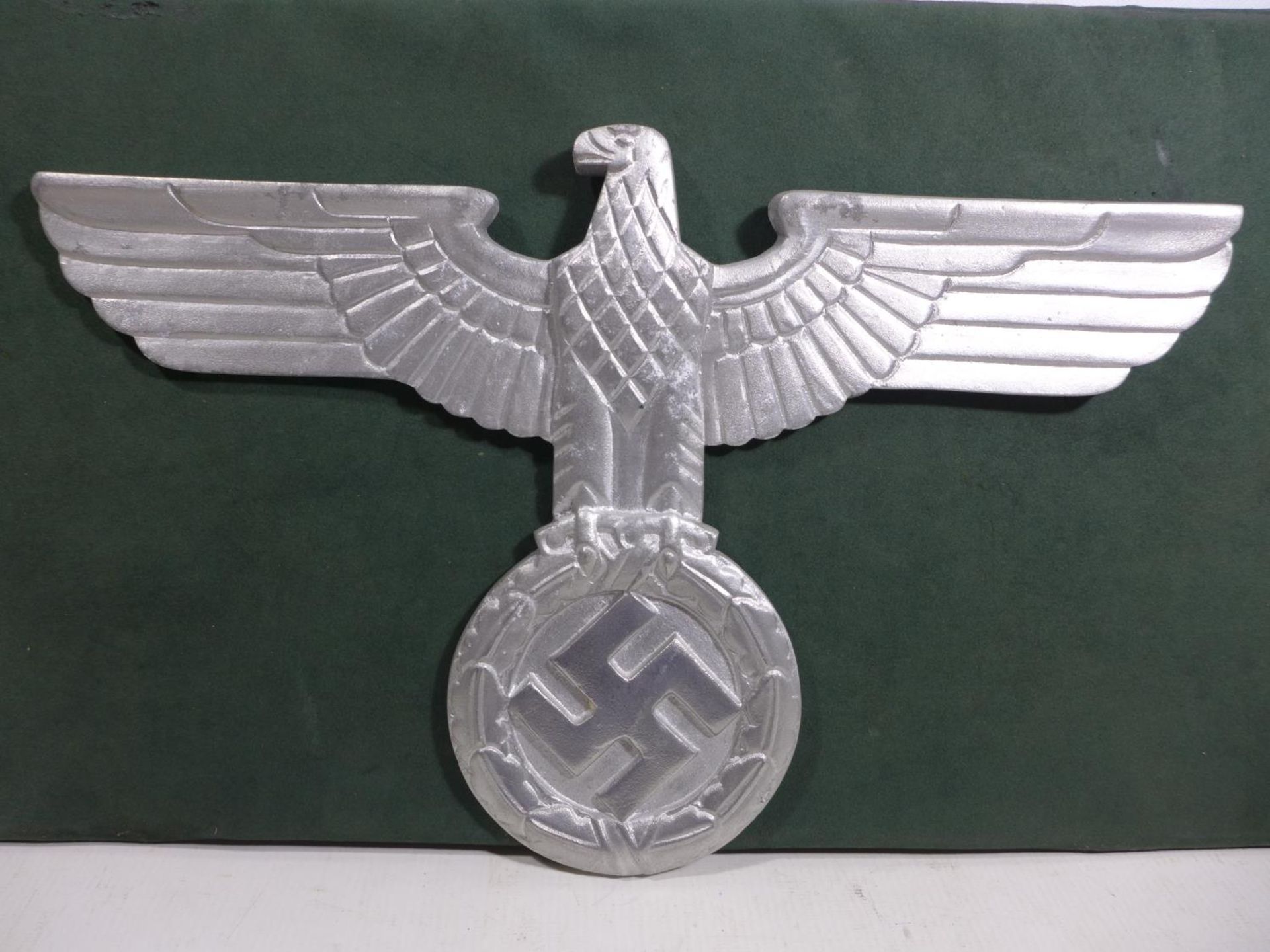 A LARGE ALUMINIUM EAGLE AND SWASTIKA PLAQUE, WIDTH 38CM, HEIGHT 24.5CM