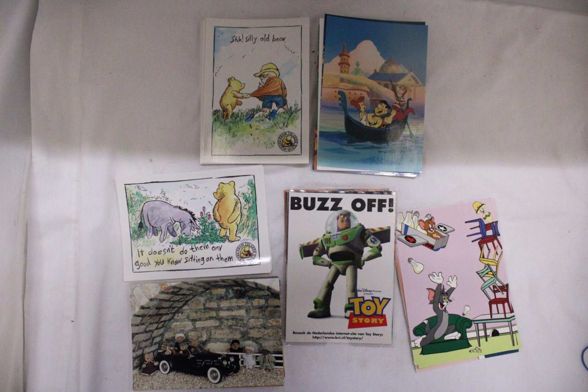 A COLLECTION OF WINNIE THE POOH, THE FLINSTONES AND TOM AND JERRY POSTCARDS
