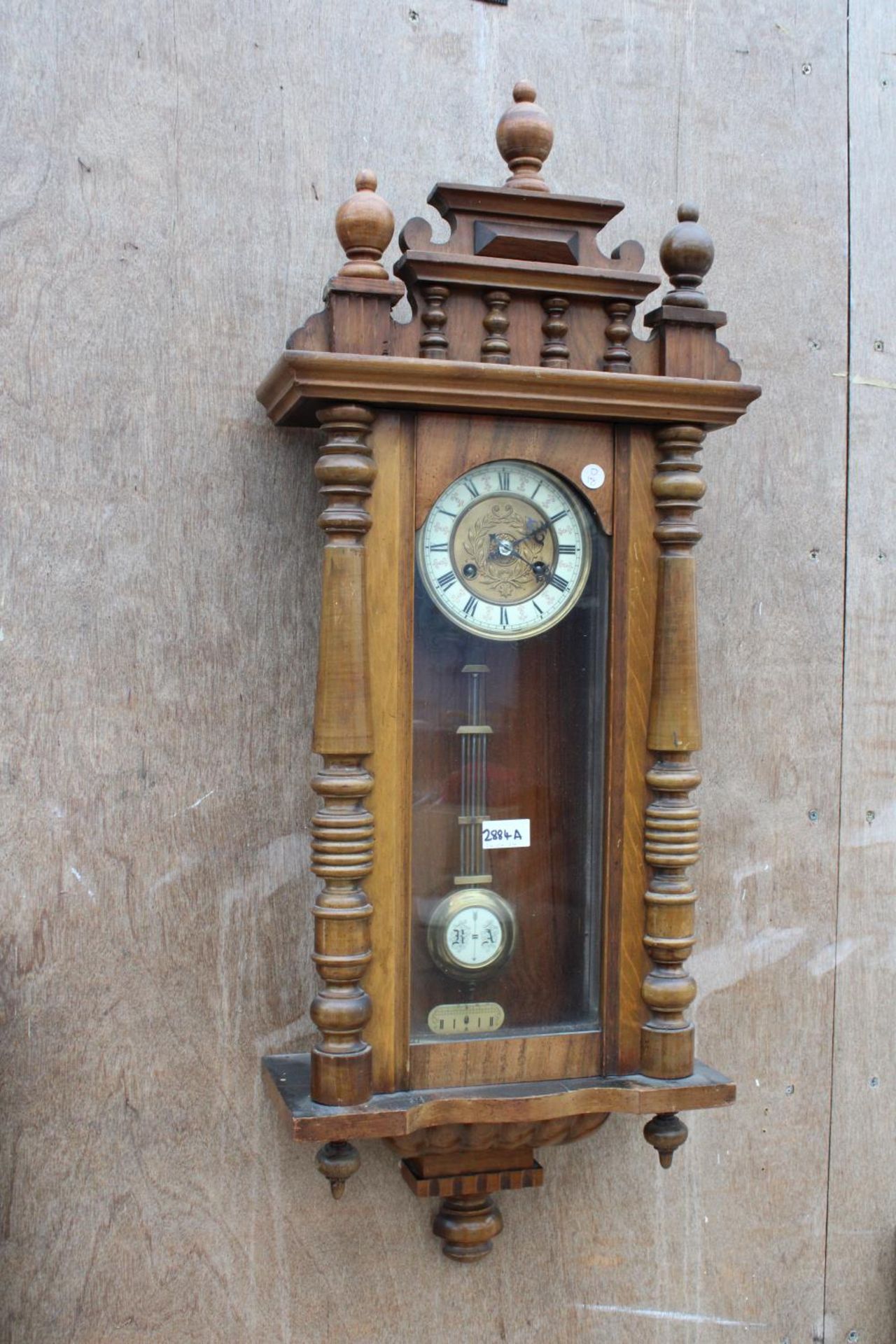 A VICTORIAN EIGHT DAY WALL CLOCK WITH ROMAN NUMERALS
