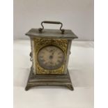 AN OFFICER'S ALARM CLOCK WITH BRASS DECORATION AND LION HEADS TO THE SIDE