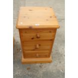 A MODERN PINE THREE DRAWER BEDSIDE CHEST