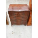 A REPRODUCTION MAHOGANY SERPENTINE CHEST OF DRAWERS WITH PULL OUT WRITING SLIDE AND FOUR LONG