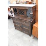 AN OAK JACOBEAN STYLE COURT CUPBOARD WITH GLAZED AND LEADED UPPER PORTION, 54" WIDE