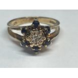 A 9 CARAT GOLD RING WITH A CLUSTER OF DIAMONDS AND SAPPHIRES SIZE K/L