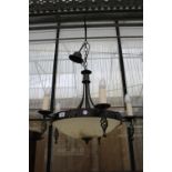 A DECORATIVE WROUGHT IRON FIVE BRANCH CIELING LIGHT FITTINGS WITH GLASS BOWL SHADE