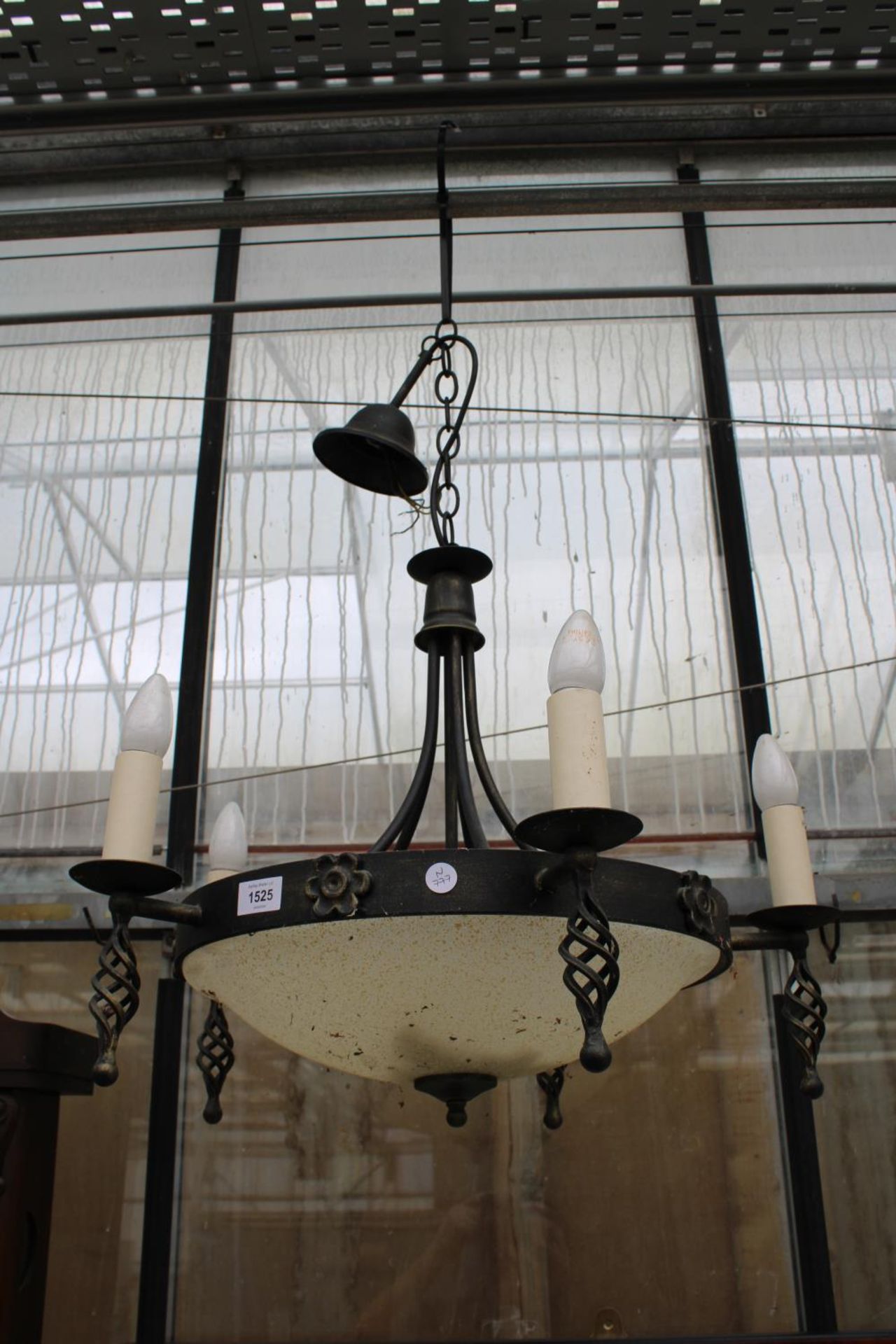 A DECORATIVE WROUGHT IRON FIVE BRANCH CIELING LIGHT FITTINGS WITH GLASS BOWL SHADE
