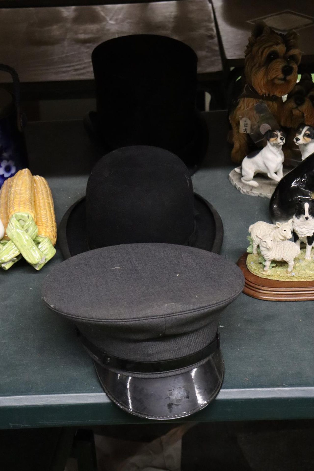 THREE VINTAGE HATS TO INCLUDE A BOWLER, SIZE 6 3/4, A PEAKED CAP AND A TOP HAT - A/F