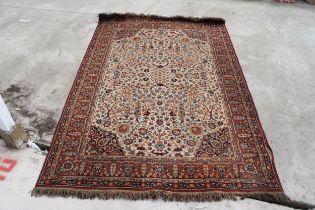 A VINTAGE RED PATTERNED FRINGED RUG