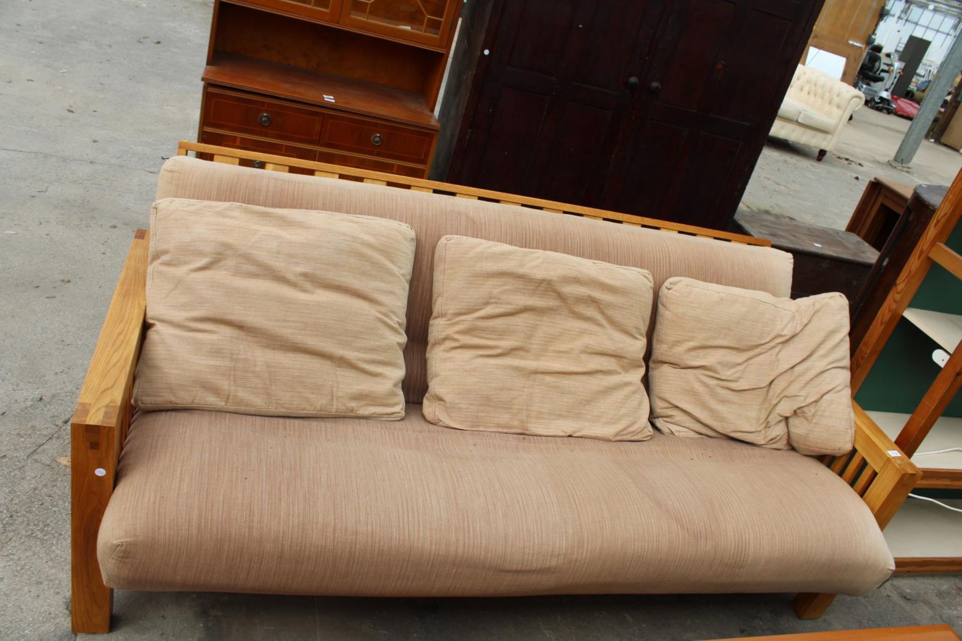 A MODERN FUTON COMPANY OAK FRAMED BED SETTEE