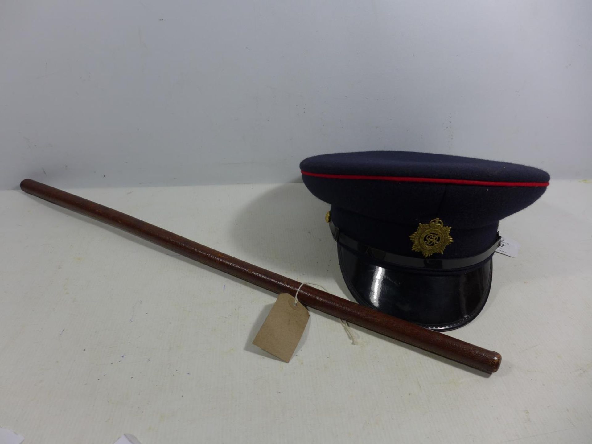 A ROYAL ARMY SERVICE CORP CAP SIZE 58 AND A LEATHER SWAGGER STICK