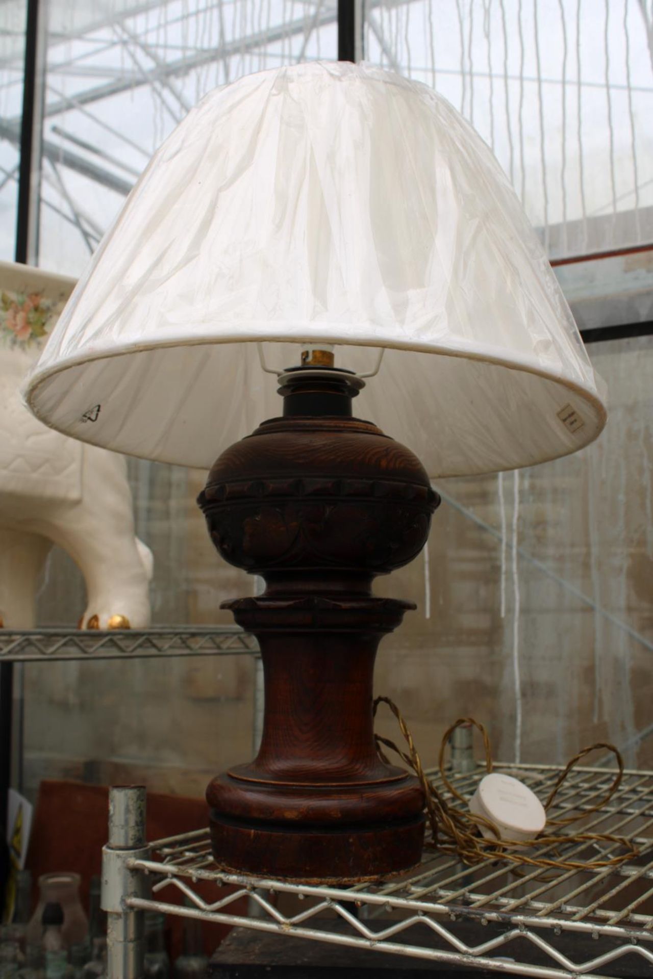 AN OAK CARVED TABLE LAMP