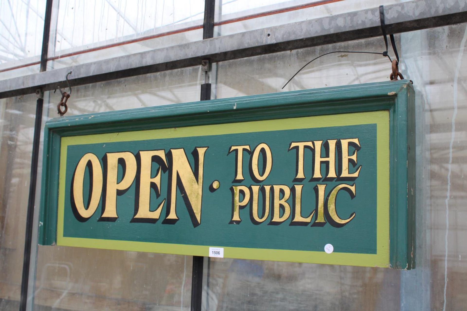 A HAND PAINTED 'OPEN TO THE PUBLIC' WOODEN SIGN