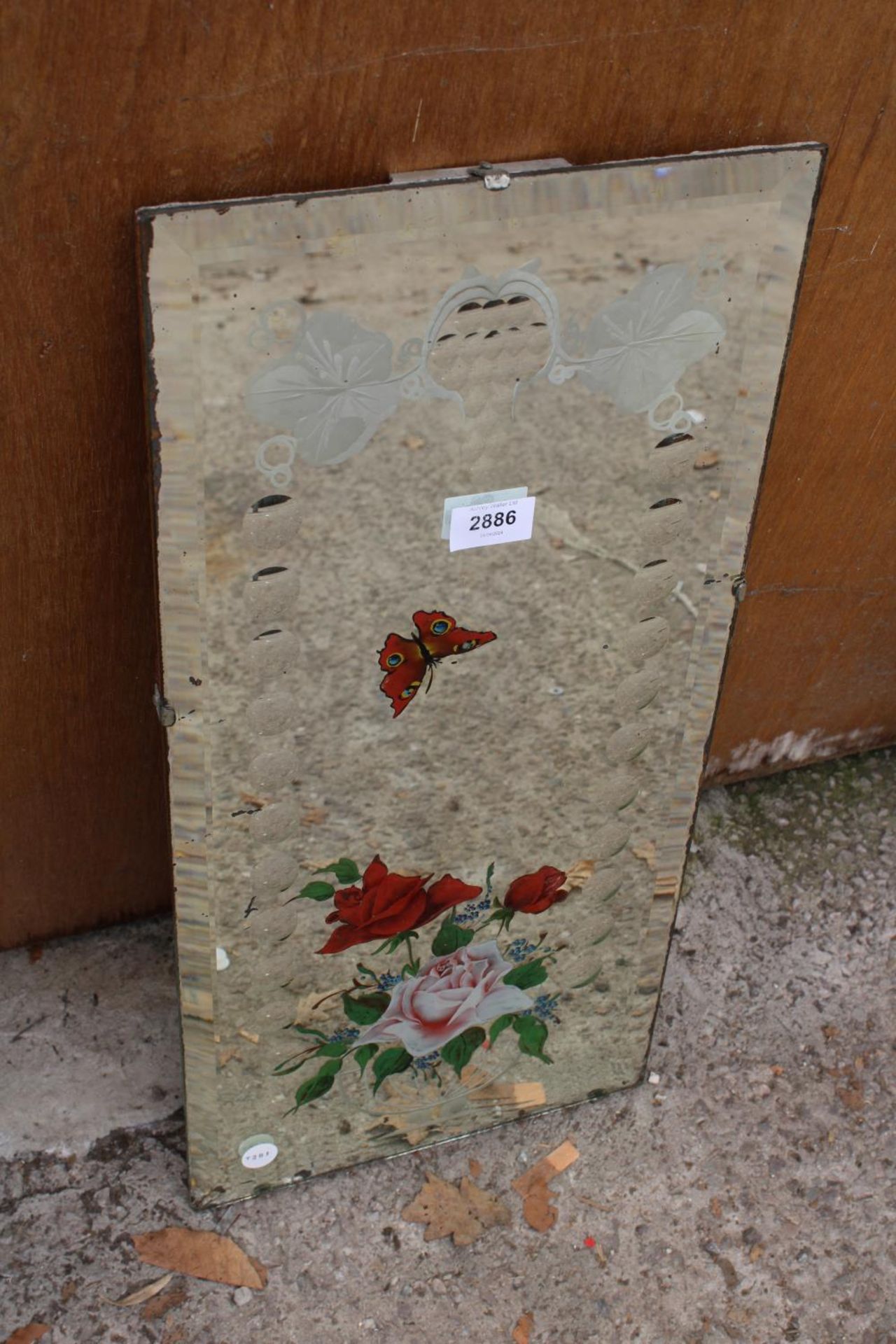 A MID 20TH CENTURY FRAMELESS WALL MIRROR WITH FLORAL AND BUTTERFLY DECORATION 23" X 11"