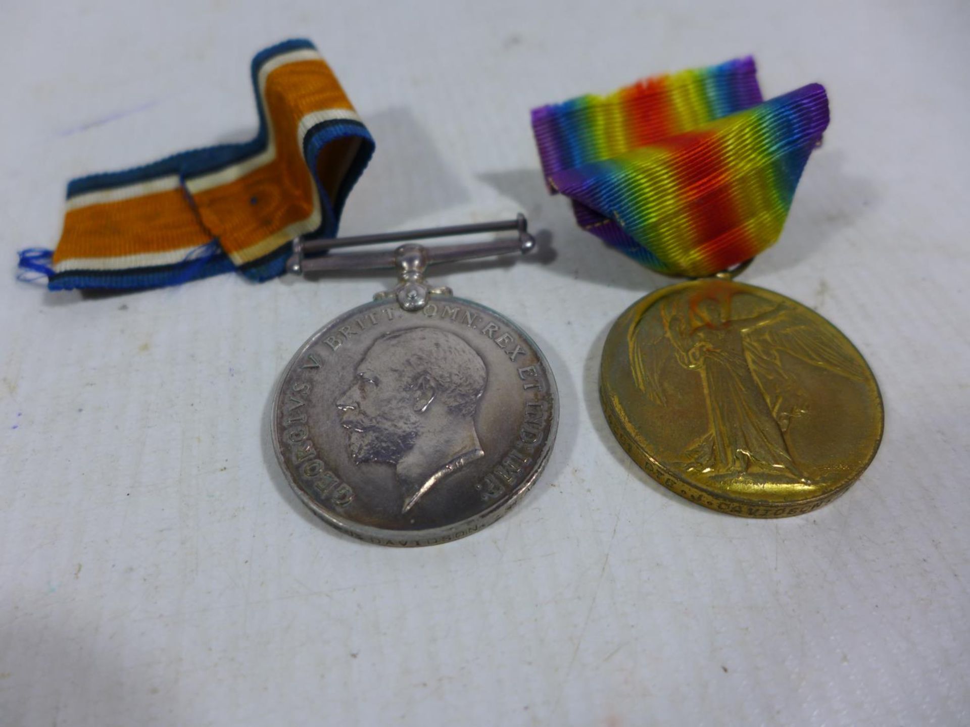 A WORLD WAR I MEDAL PAIR AWARDED TO S-14391 PRIVATE J DAVIDSON SEAFORTH HIGHLANDERS