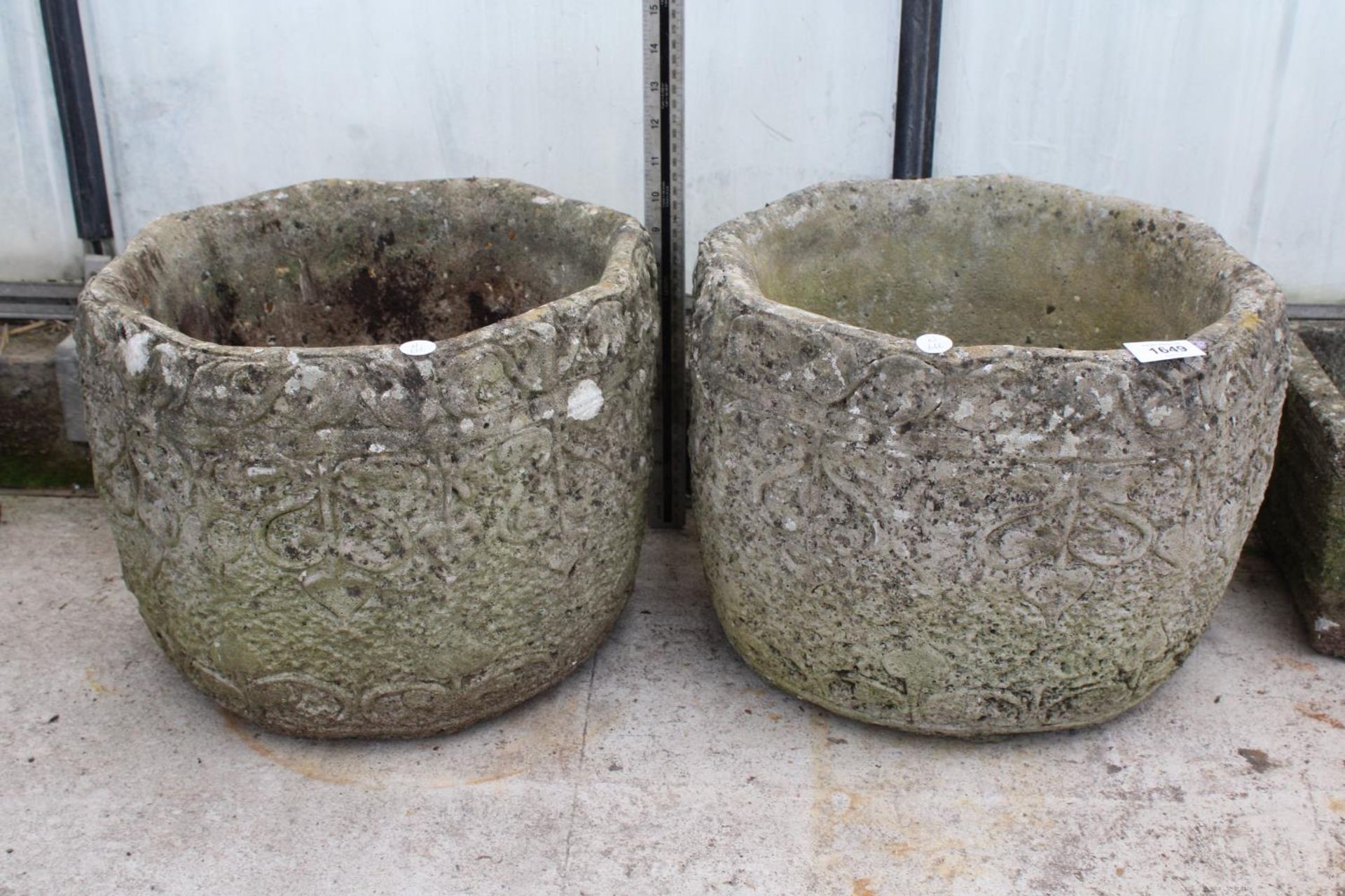 A MATCHING PAIR OF RECONSTITUTED STONE GARDEN PLANTERS