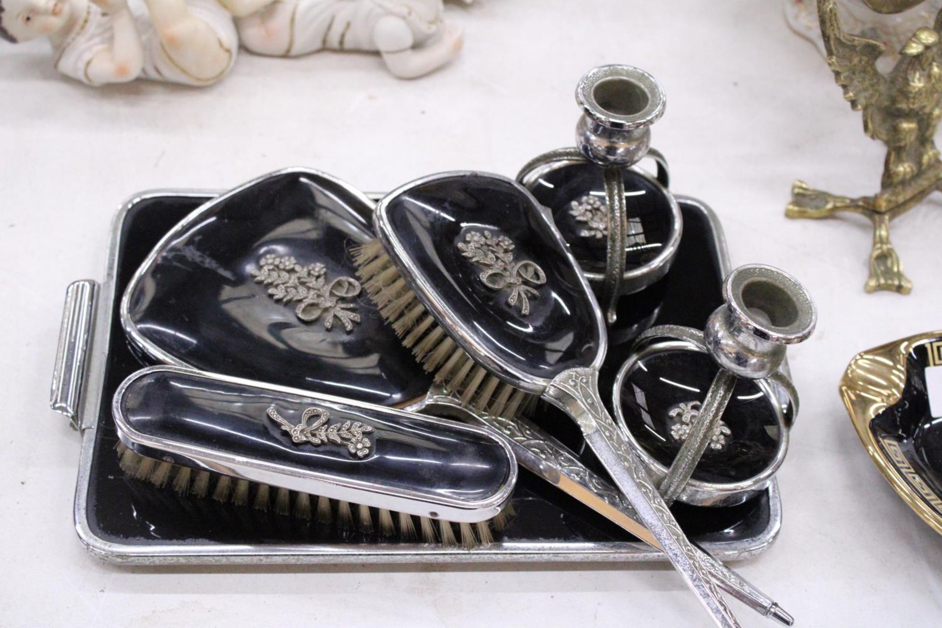 A VINTAGE BLACK DRESSING TABLE VANITY SET TO INCLUDE A HAND MIRROR, TWO BRUSHES AND TRAY - PLUS