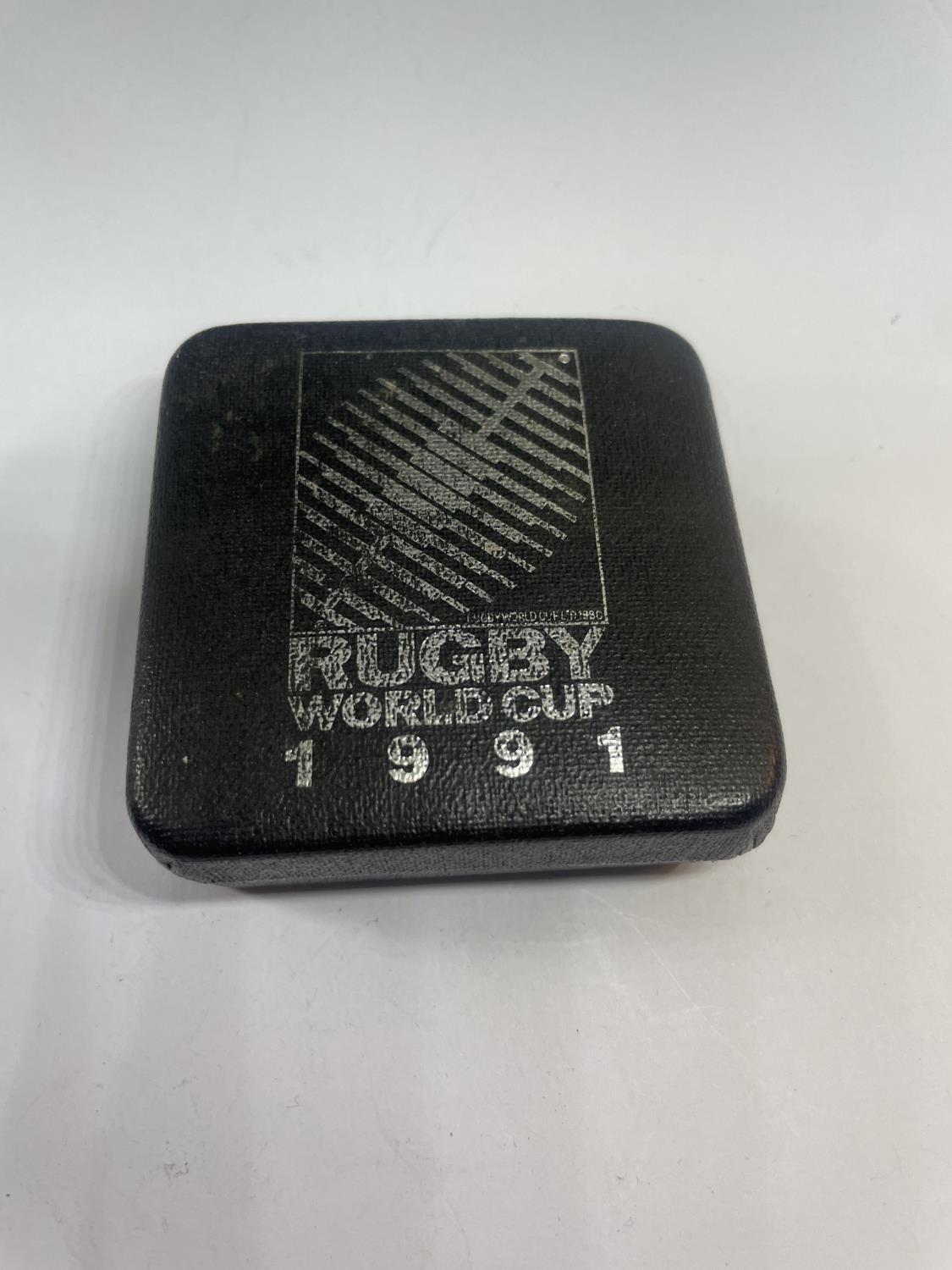A SILVER 1991 RUGBY WORLD CUP MEDAL IN A PRESENTATION BOX - Image 4 of 4