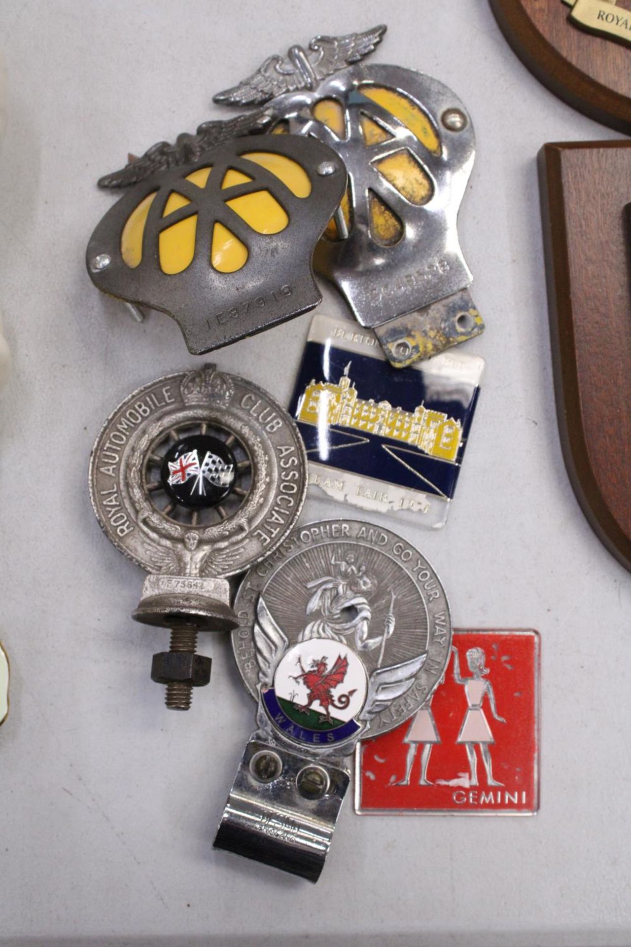 FOUR VINTAGE CAR BADGES TO INCLUDE THE AA, PLUS TWO OTHERS