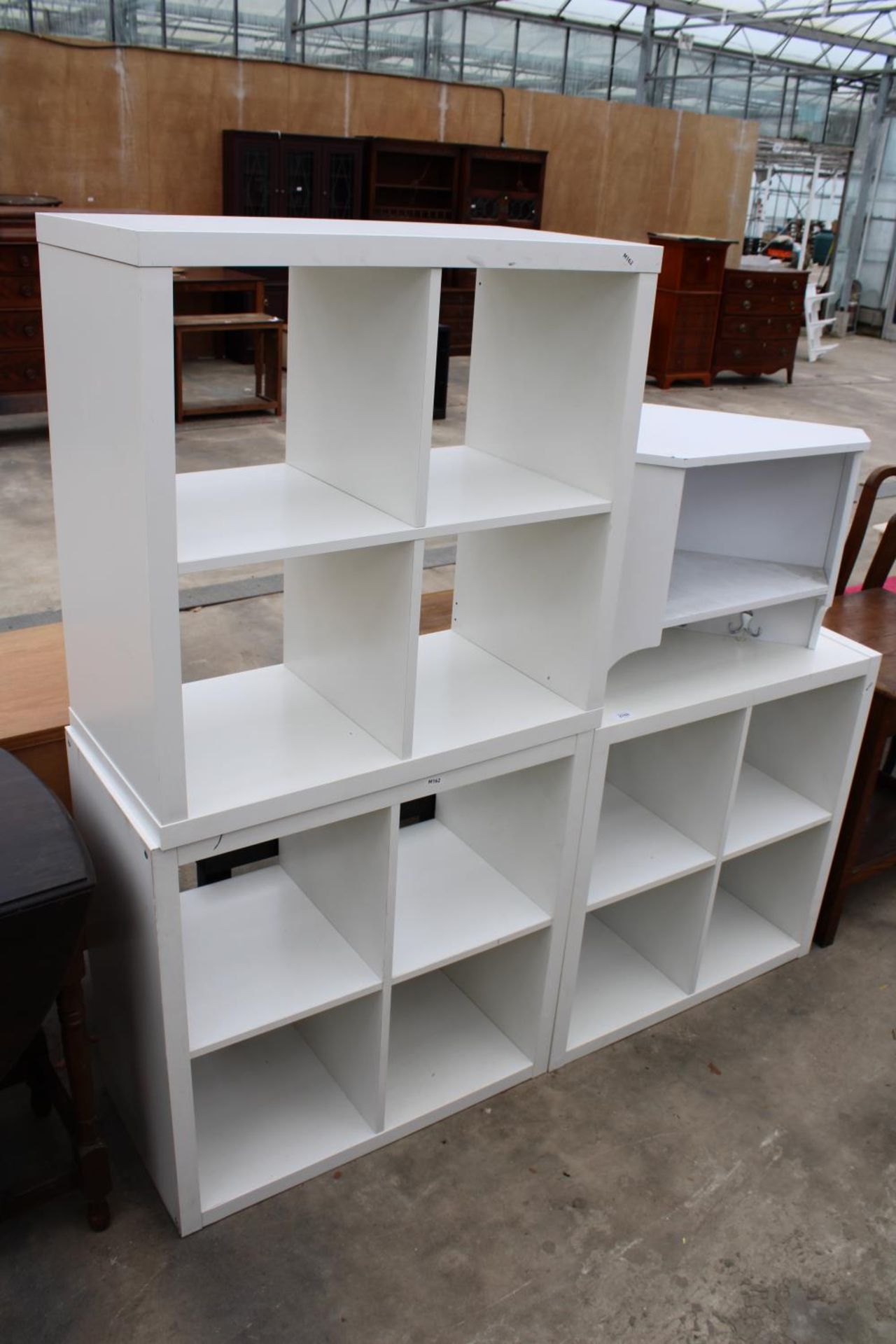 THREE SETS OF WHITE OPEN DISPLAY SHELVES AND A HANGING CORNER UNIT WITH COAT HOOKS
