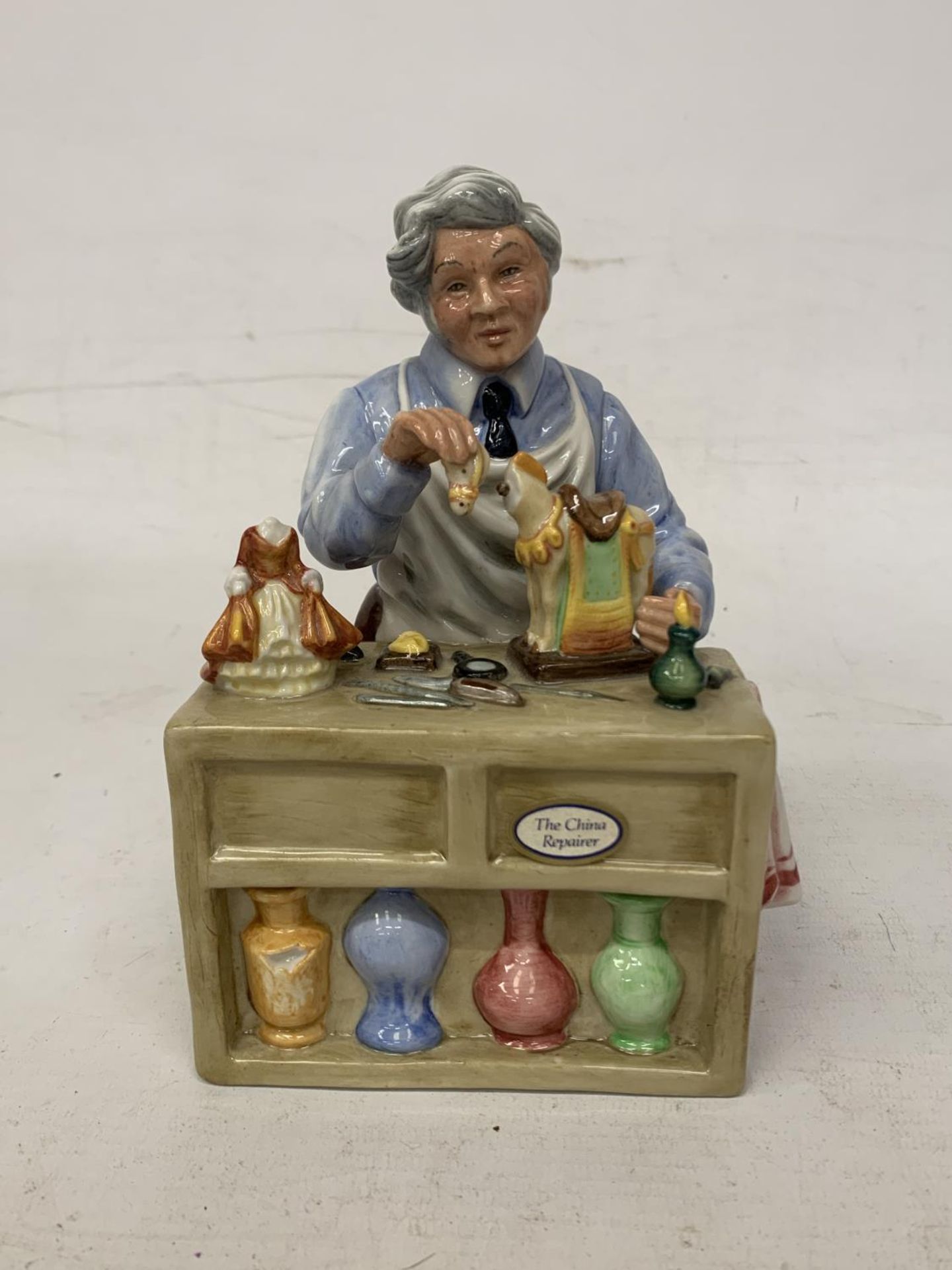 A ROYAL DOULTON FIGURE "THE CHINA REPAIRER" HN 2943