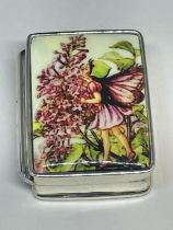 A SILVER PILL BOX WITH ENAMEL FAIRY DESIGN TOP