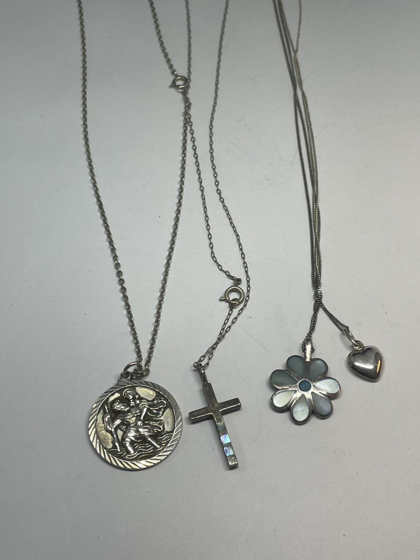 FOUR SILVER NECKLACES WITH PENDANTS