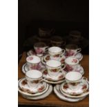 A COLLECTION OF VINTAGE CHINA TRIOS TO INCLUDE FENTON AND ROSLYN, PLUS CAKE PLATES, A CREAM JUG